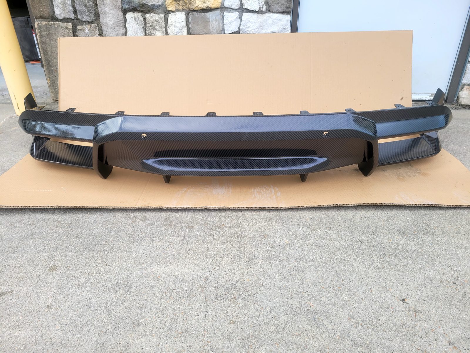 BMW X6 carbon fiber rear diffuser after sanding, patch repairs and fresh clear coat