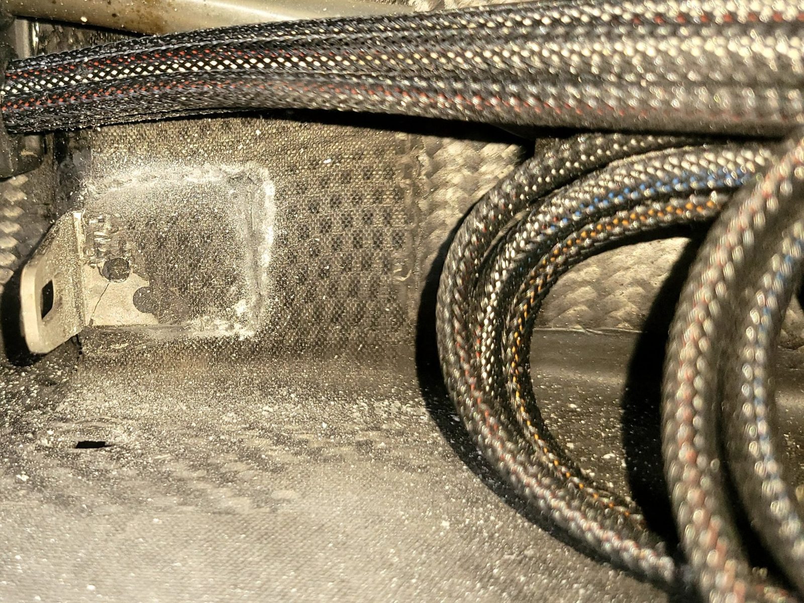Jetsurf carbon fiber board interior with a hole in the hull next to a bracket before repair