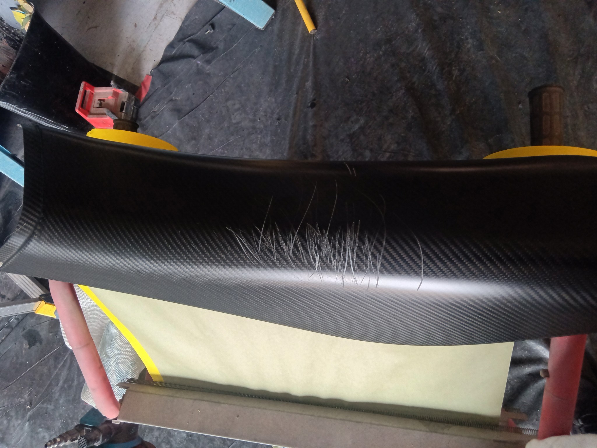 McLaren door panel — clear coat damage before repair