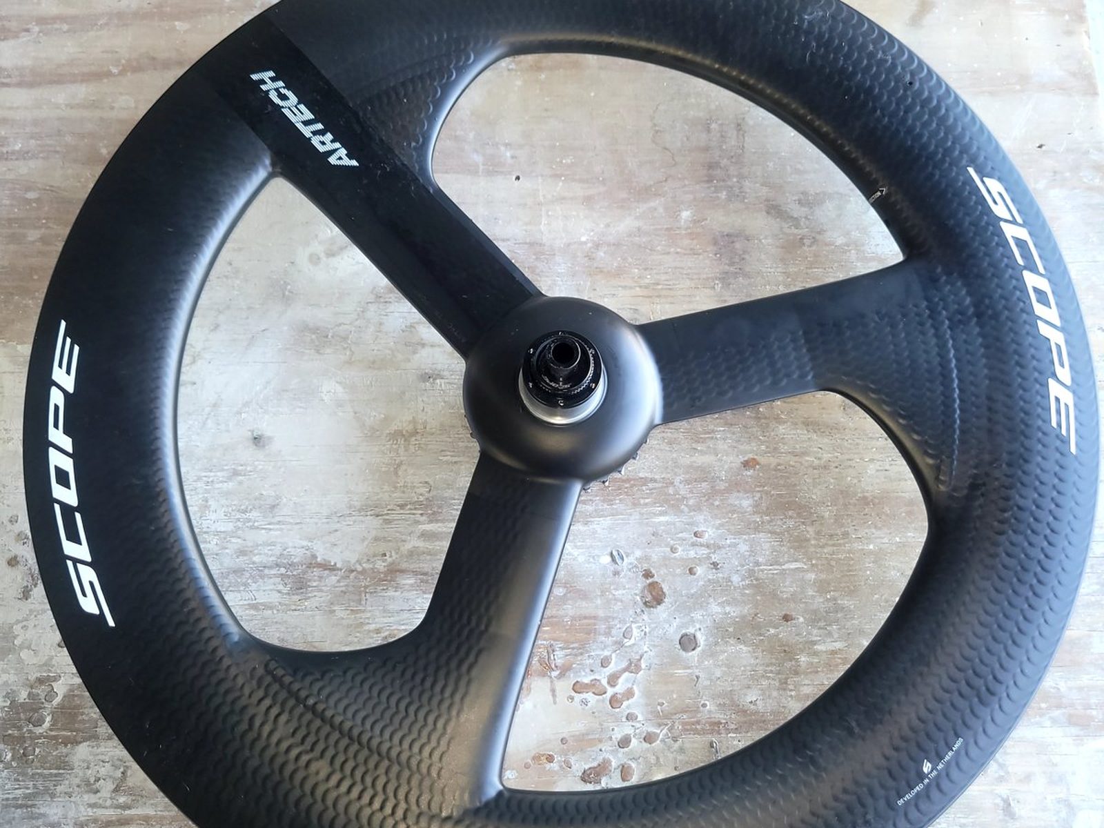 One-off prototype carbon fiber trispoke time-trial wheel, repaired for a three-time Ironman World Champion
