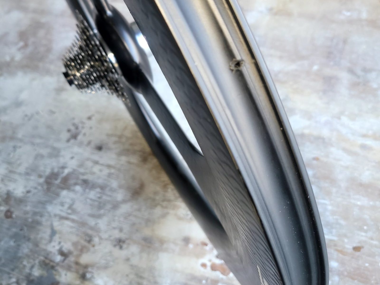 Side profile of a repaired deep-section carbon fiber trispoke wheel